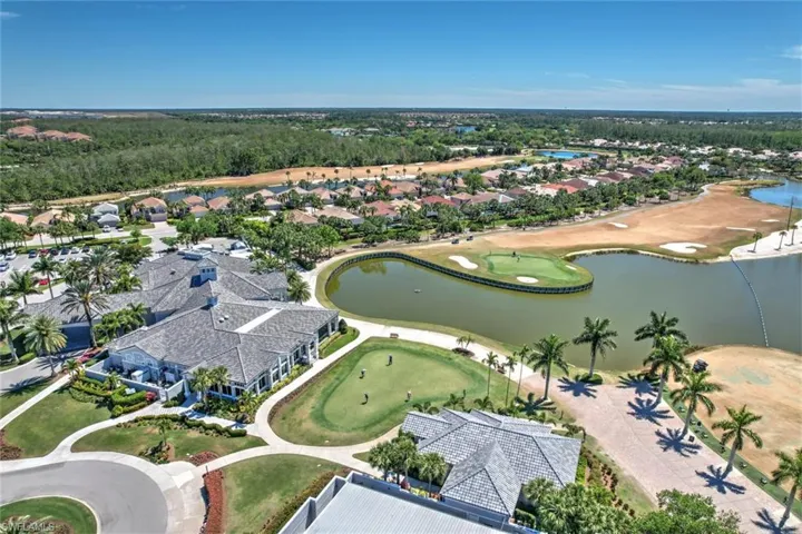 Birds eye view of property with a water view and view of golf course