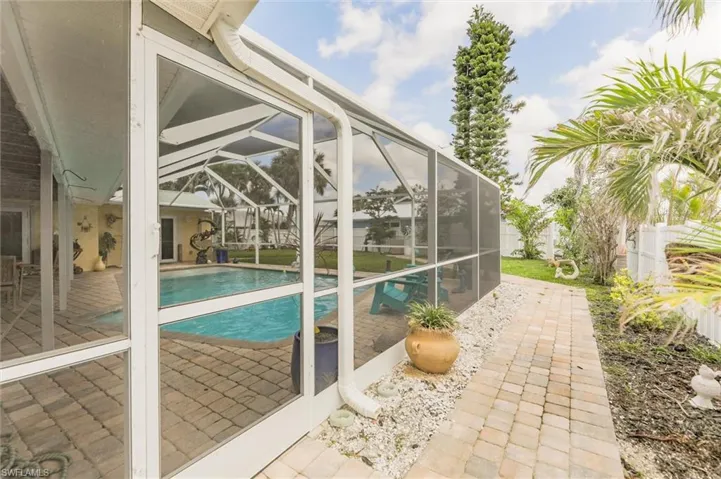 View of swimming pool with a patio, a fenced backyard, and a lanai
