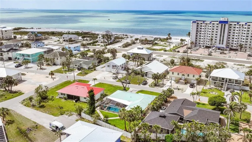 Aerial view with a water view, a beach view, and a residential view