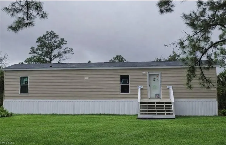 Front of home with entry steps.