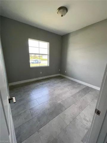 Unfurnished room with tile flooring