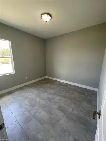 Empty room featuring tile flooring