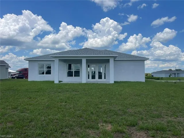 Rear view of house with a yard