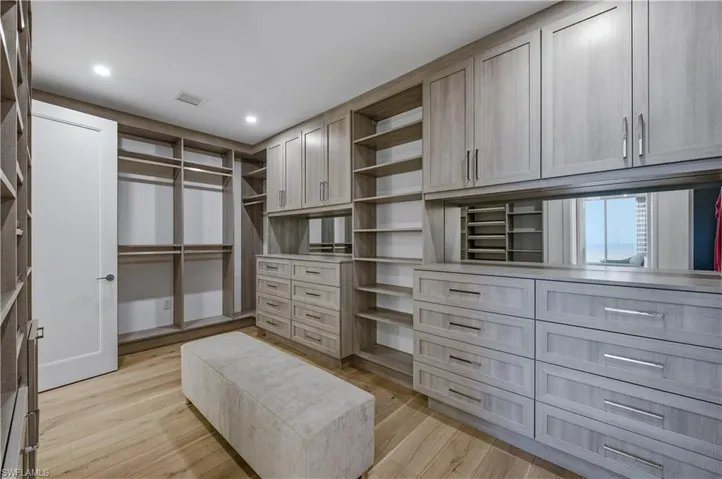 Walk in closet with light wood-type flooring