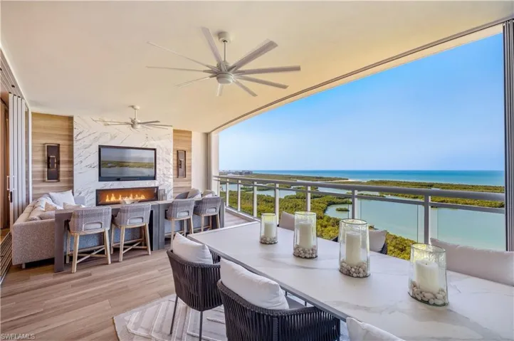 Balcony featuring outdoor dining space and a ceiling fan
