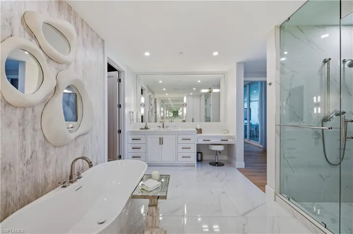 Full bathroom with vanity, a marble finish shower, recessed lighting, a freestanding tub, and light marble finish flooring