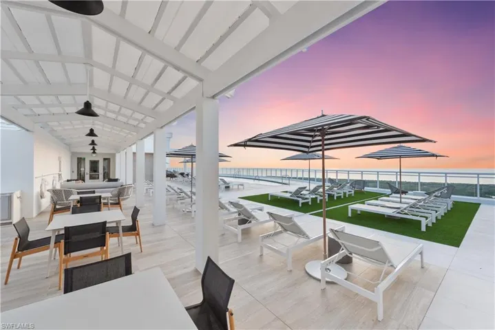 Patio terrace at dusk with outdoor dining space, a patio area, and ceiling fan