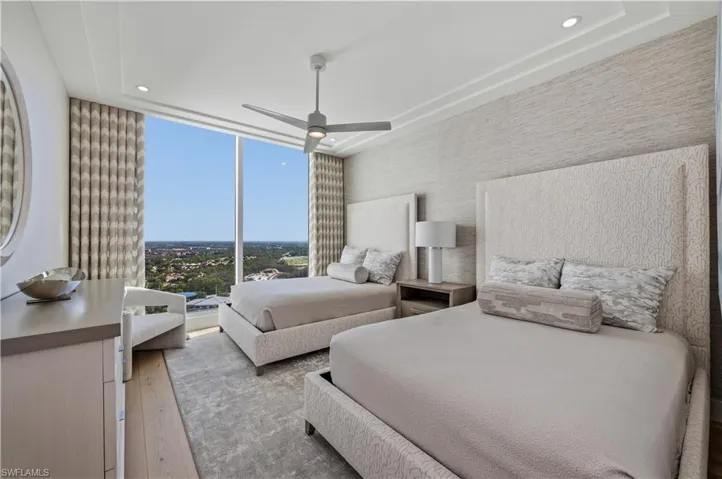 Bedroom featuring ceiling fan, expansive windows, light wood finished floors, recessed lighting, and wallpapered walls