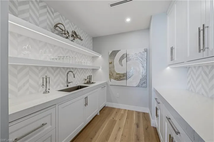 Bar featuring open shelves, tasteful backsplash, white cabinetry, and recessed lighting