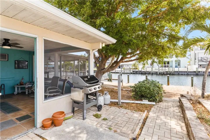 This expansive outdoor space is designed for grilling and entertaining, with direct access to the lanai for easy serving and enjoying meals outdoors.