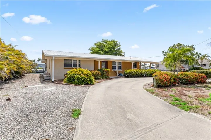 Curb Appeal on a Double Lot – Set on the largest lot in Matlacha, the home’s wide and open frontage offers room to breathe, with vibrant palms, flowering plants, and plenty of space to park or play.