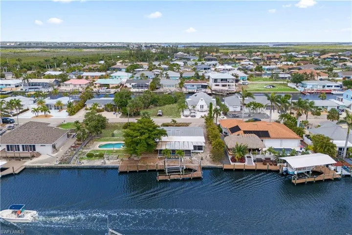 Aerial view showcasing the expansive lot, pool, and private dock.