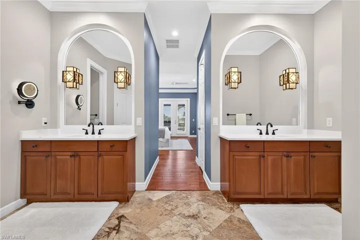 Full bathroom featuring two vanities, recessed lighting, and crown molding