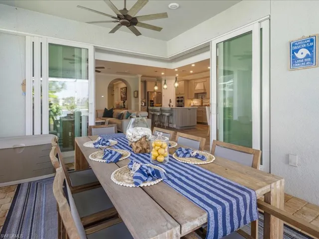 The Dining area on the outdoor screened lanai allows that indoor/outdoor flow with the zero sliders, ideal for entertaining