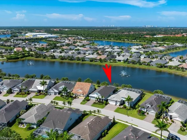 Drone / aerial view of the residence with a view of the water feature