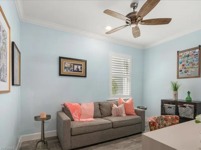 This guest bedroom is being used as a den, however it is generous in size and features plantation shutters and the same neutral palette