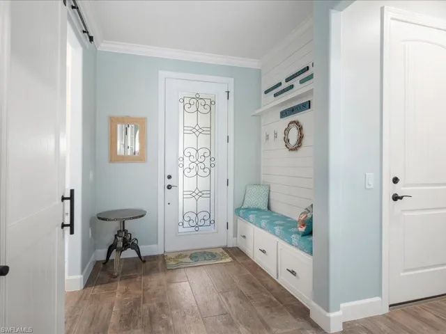 Mudroom or drop zone is recently designed with a custom feature wall and built in bench for seating and storage