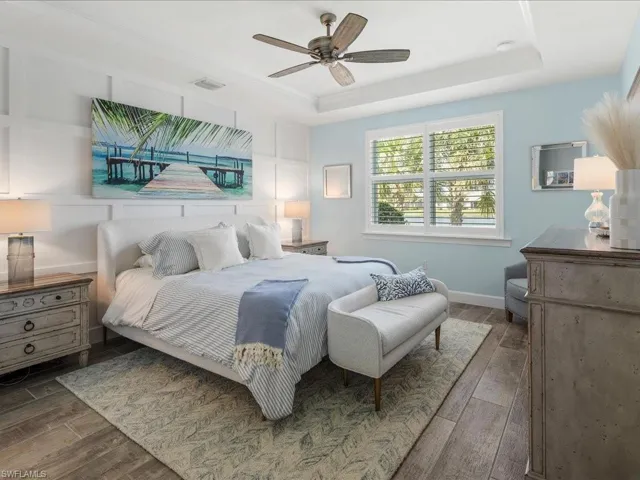 Primary Bedroom with tray ceiling, plantation shutters and plenty of natural light