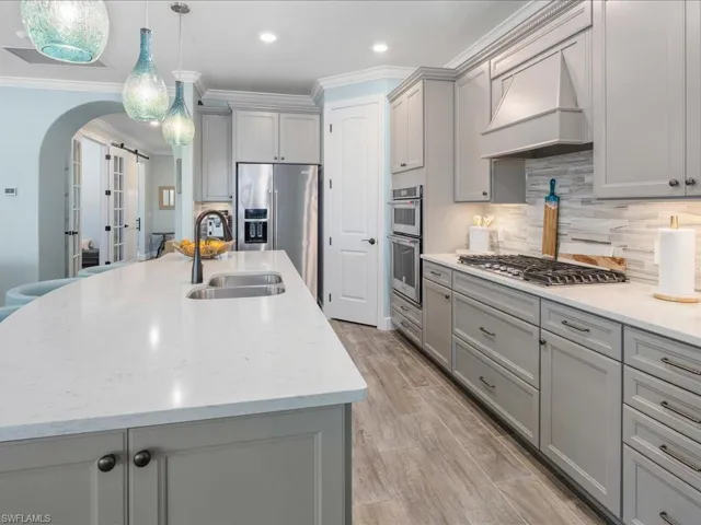 Kitchen features a generous pantry and plenty of custom cabinetry for storage