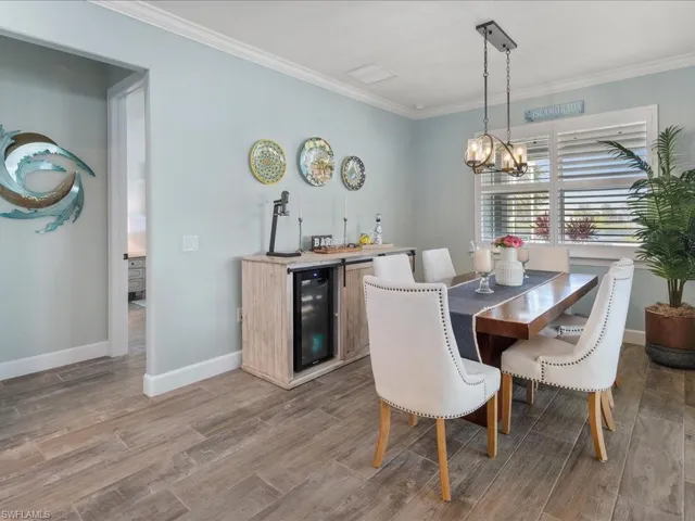 The wood like plank tile flooring throughout blends nicely with the coastal palette of colors neutral for any style
