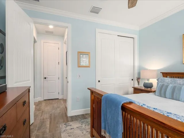 Guest Bedroom with closet, crown molding, and ceiling fan can easily be made to be en suite with the hallway closed off