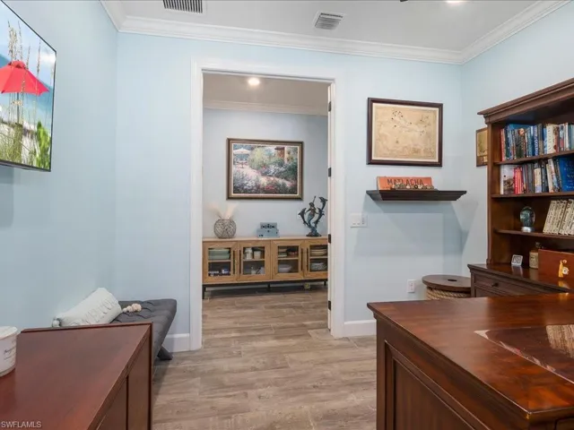 The separate den features french doors for privacy and crown molding