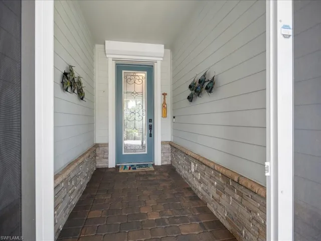 Covered, screened in front door with electric storm shutters