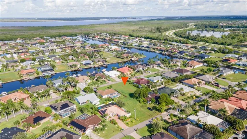 View of property location featuring a large body of water and nearby suburban area