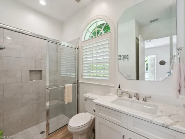 Cabana bathroom with walk in shower, toilet, and large vanity