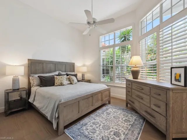 Bedroom with hardwood / wood-style floors and ceiling fan