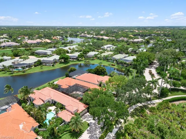 Birds eye view of property with a water view