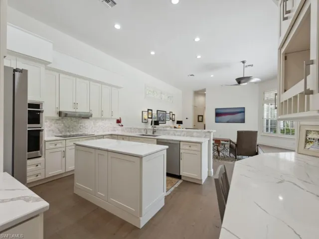 Kitchen with a center island, Quartz countertops, stainless steel appliances, and backsplash