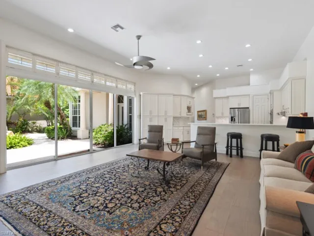 Great room with light wood-type flooring and ceiling fan