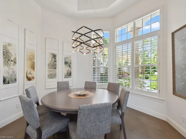 Dining area featuring a tray ceiling and chandelier