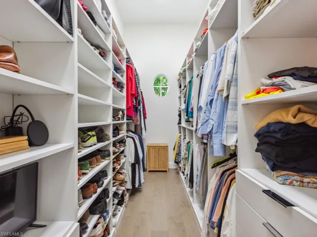 Walk in custom closet in primary bedroom