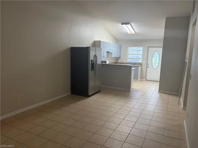 Open concept living area with vaulted ceiling