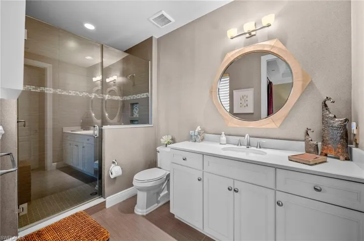 Bathroom featuring vanity, a shower stall, and recessed lighting