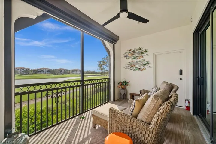 Sunroom / solarium featuring a water view and wood finished floors