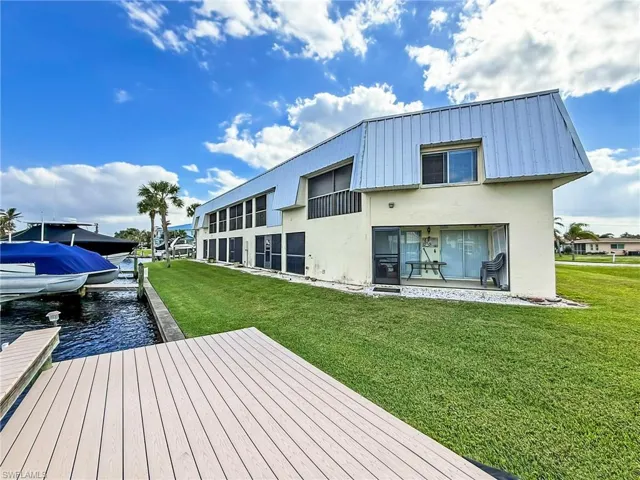 Dock area with a yard and a water view
