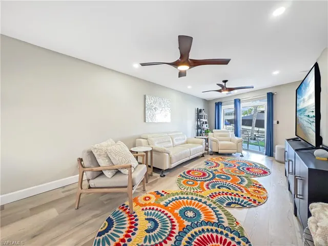 Living room featuring ceiling fan and light wood-type flooring