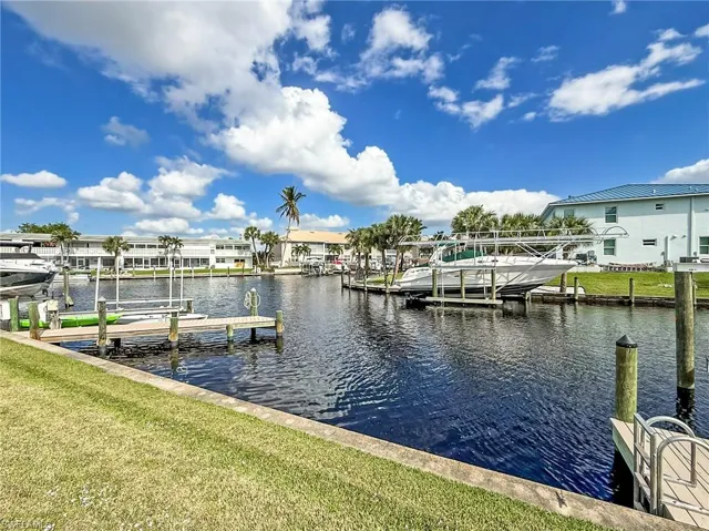 Dock area featuring a water view and a yard