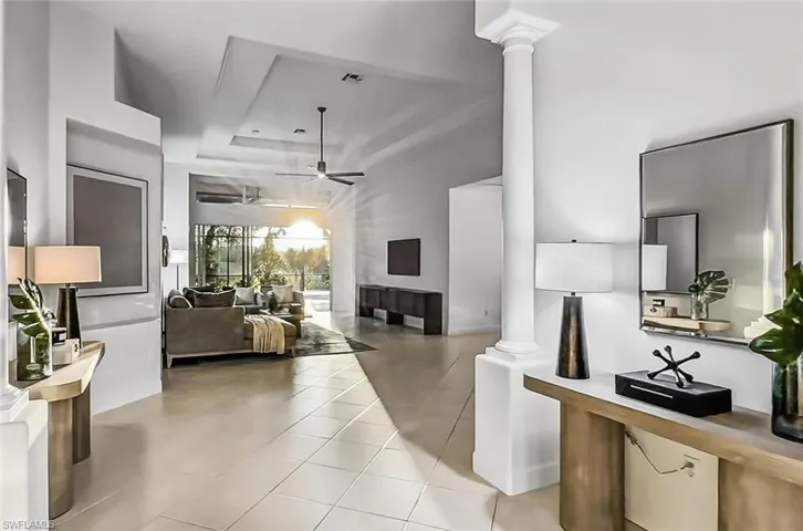 Spacious and bright expensive, open foyer with high volume entry ceiling and tray in Great Room near pool lanai.Stunning View to the pool entertainment from the front door entry for WOW factor / guest appeal!