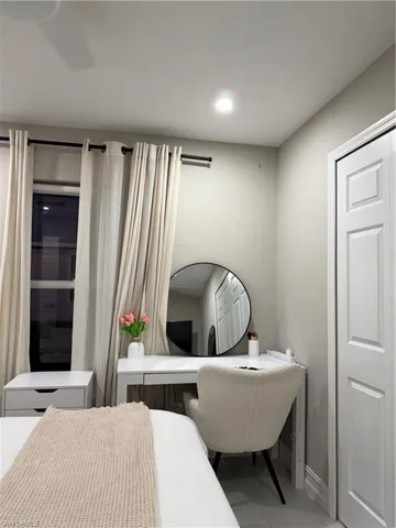 Bedroom featuring an office area, tile patterned floors, and recessed lighting