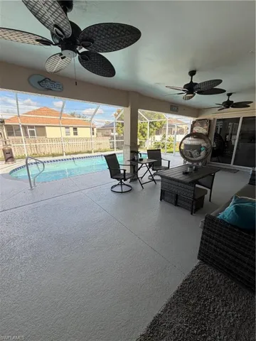 View of patio featuring ceiling fan, a sunroom, a lanai, and an outdoor hangout area