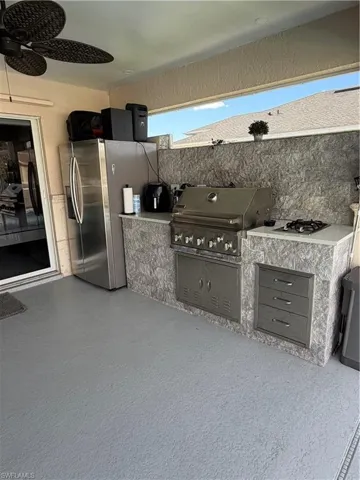 View of patio / terrace with a ceiling fan and exterior kitchen