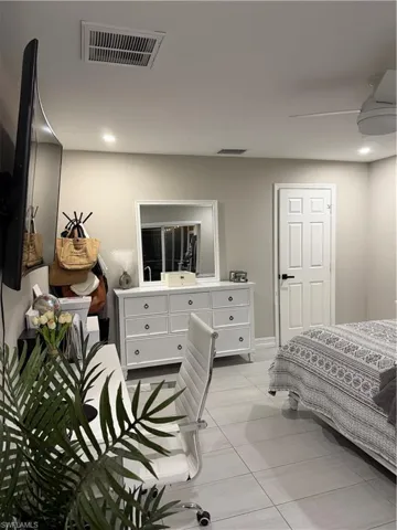 Bedroom featuring a ceiling fan, recessed lighting, and light tile patterned floors