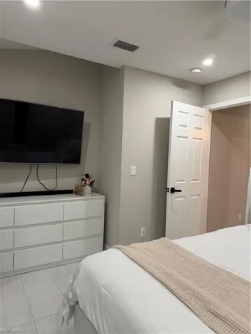 Bedroom with recessed lighting and tile patterned flooring