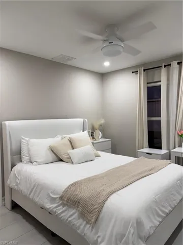 Bedroom featuring a ceiling fan and light tile patterned flooring