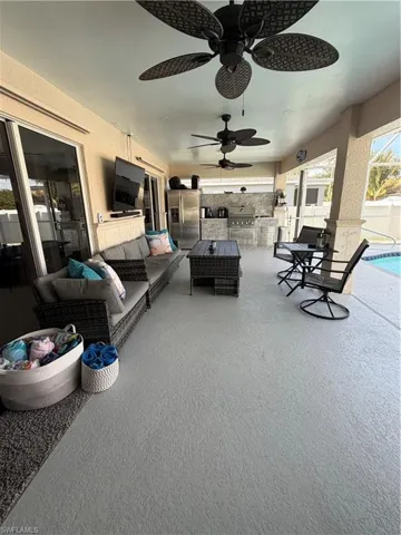 View of patio / terrace with an outdoor hangout area, a ceiling fan, and area for grilling
