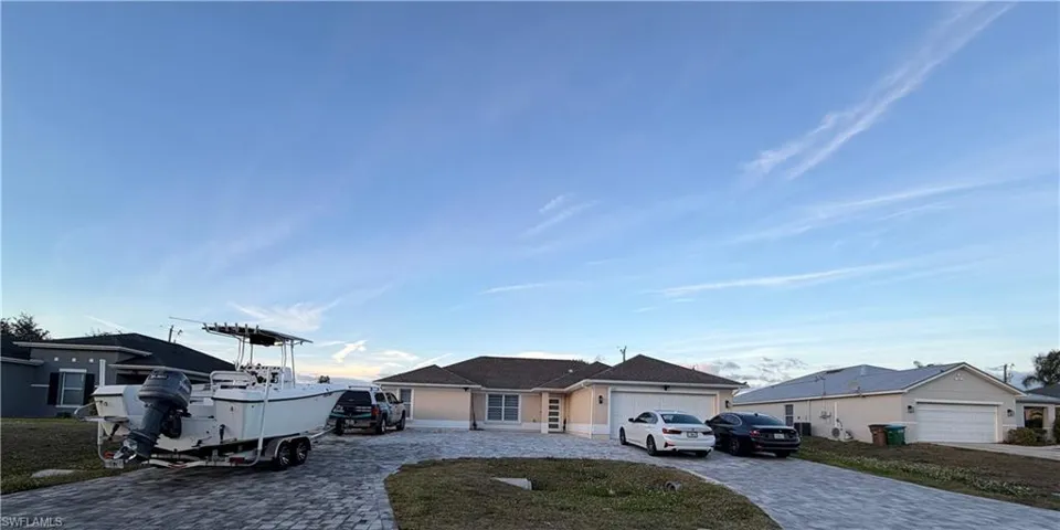 Ranch-style house with decorative driveway and an attached garage